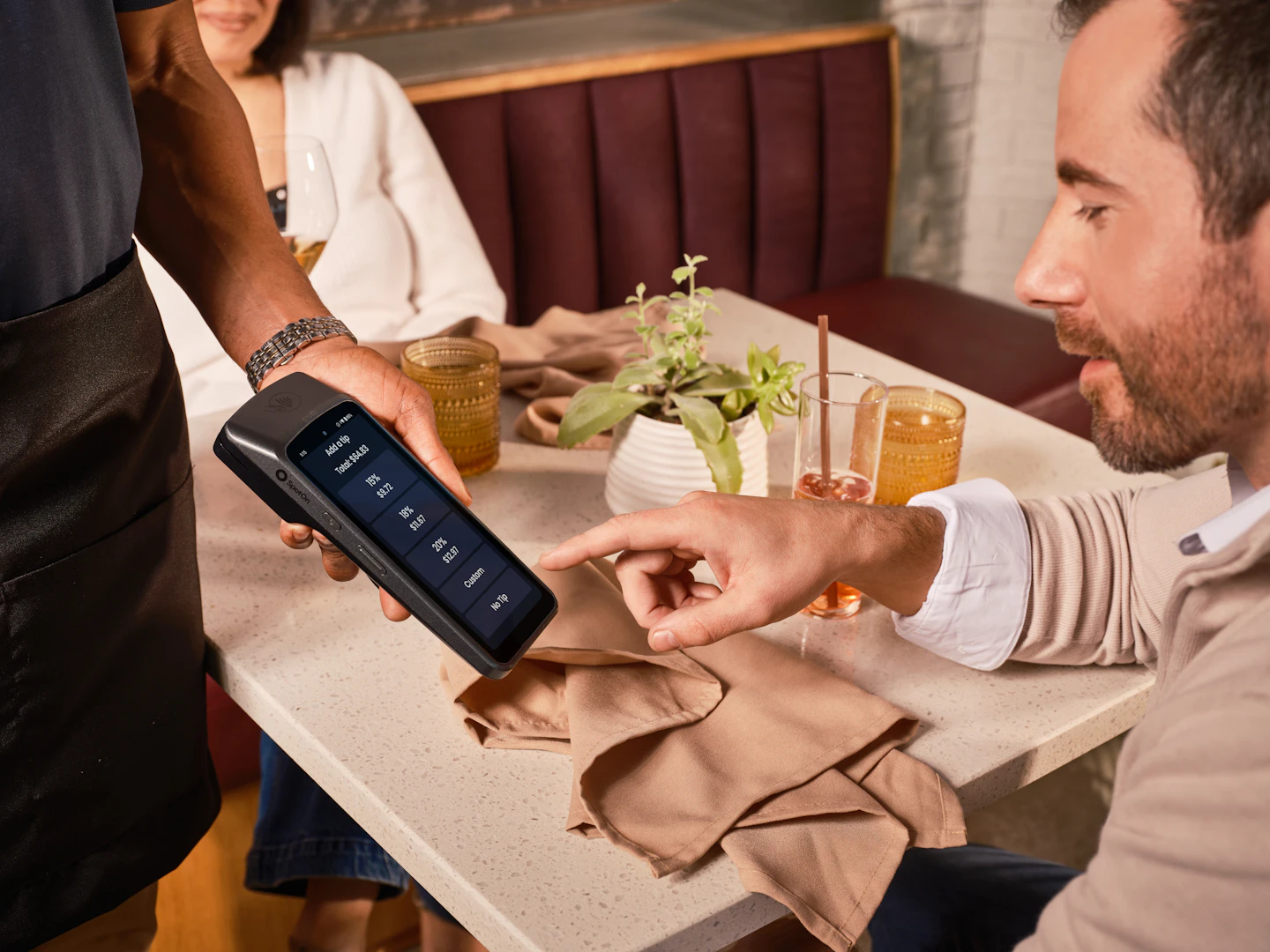 Restaurant guest completing a card payment at the table